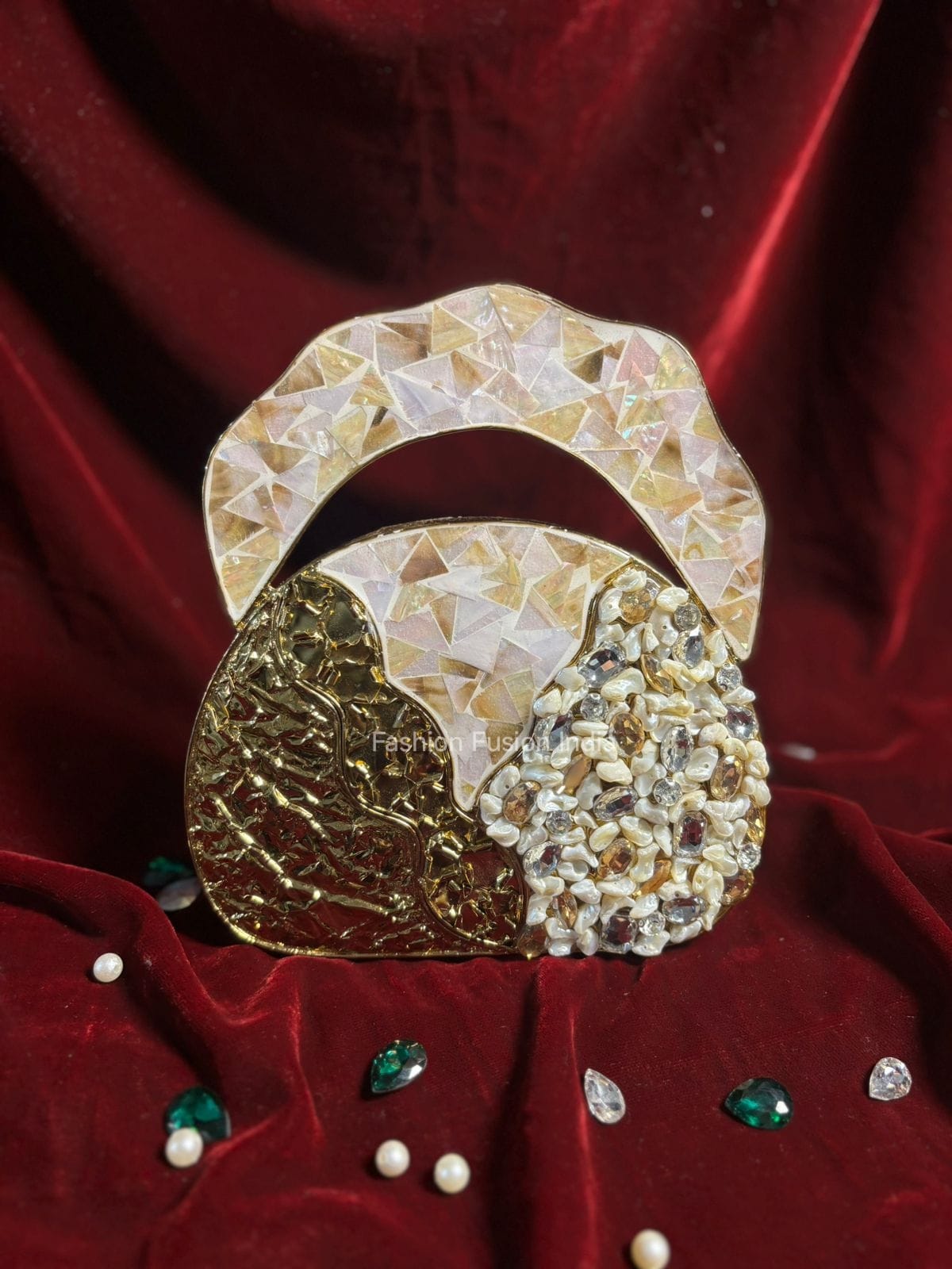 Decorative brooch with gold and pearl design on a red fabric background
