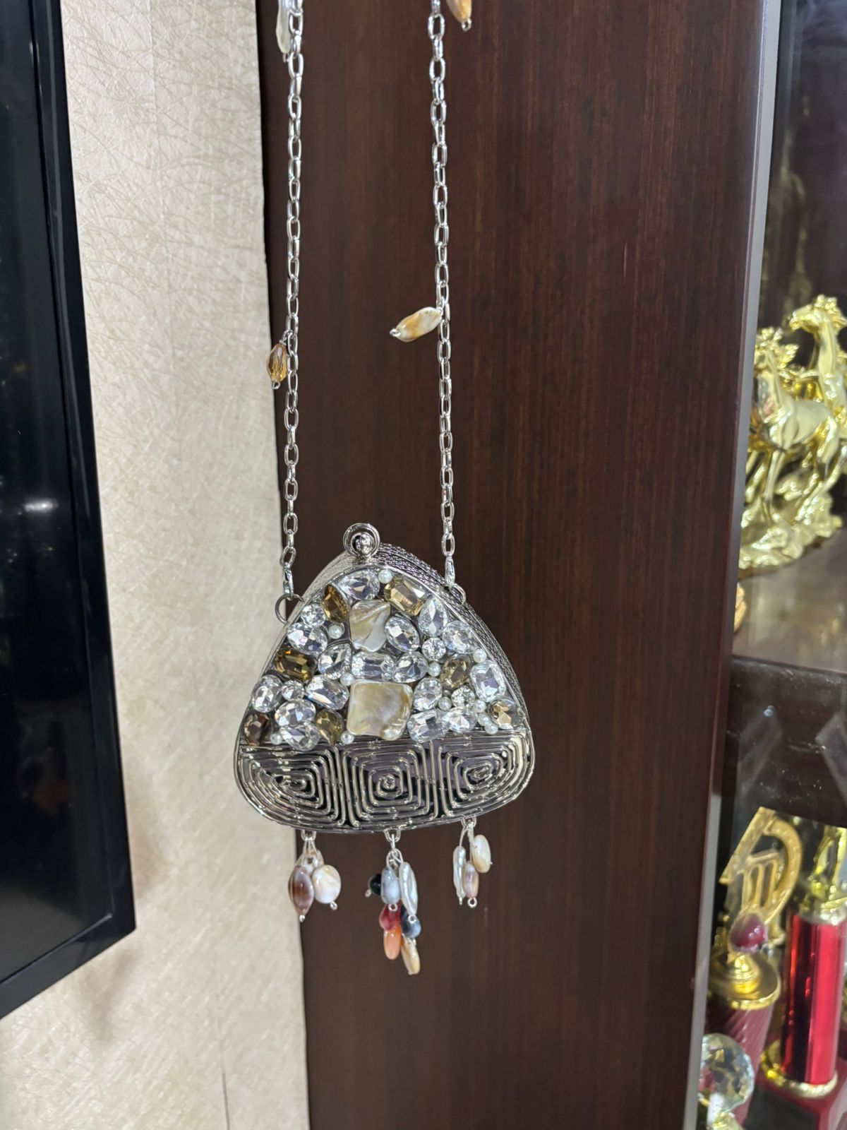 Decorative wall hanging with intricate design and colorful elements on a wooden surface.
