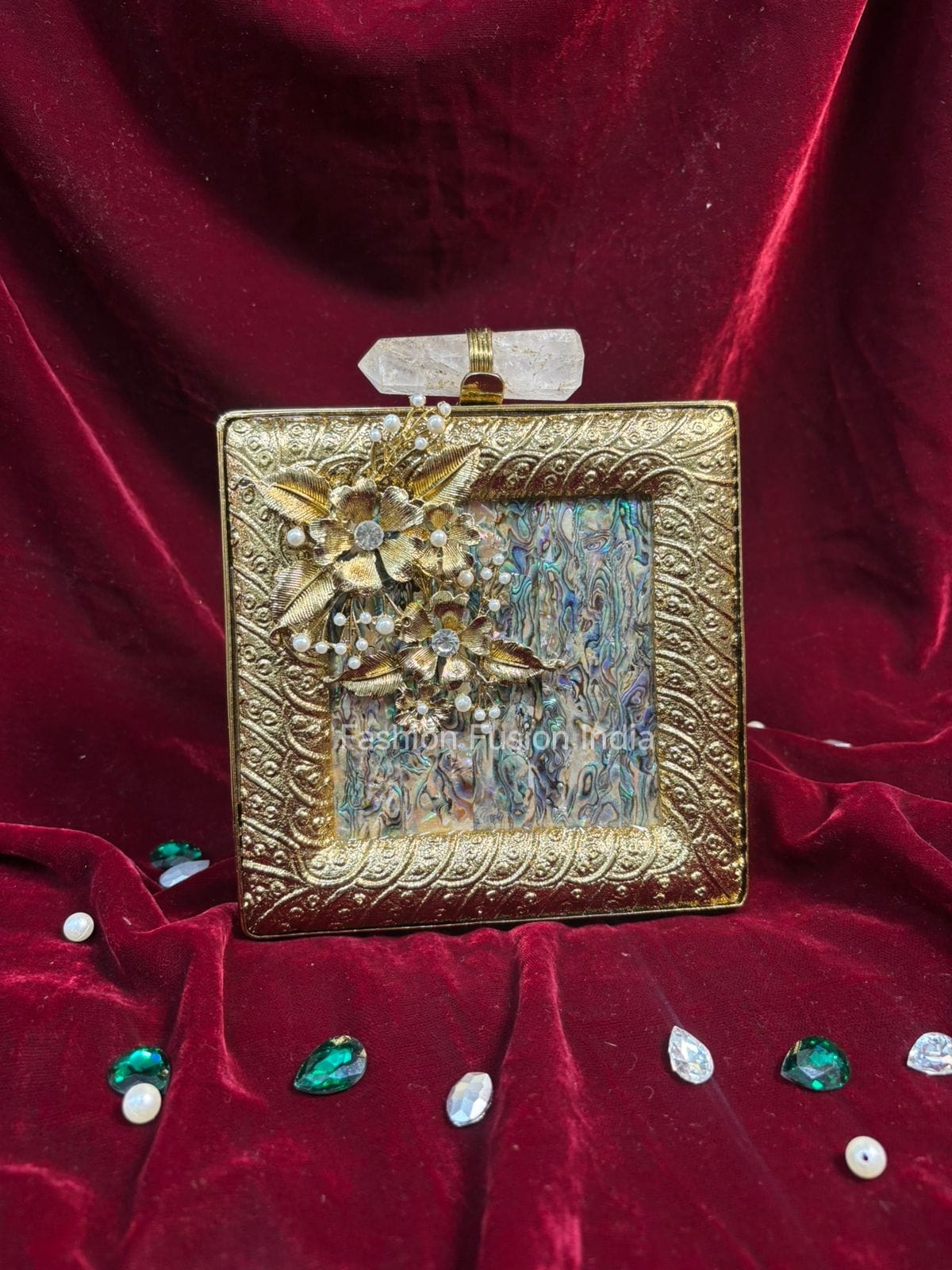 Decorative gold box with floral design on a red velvet background