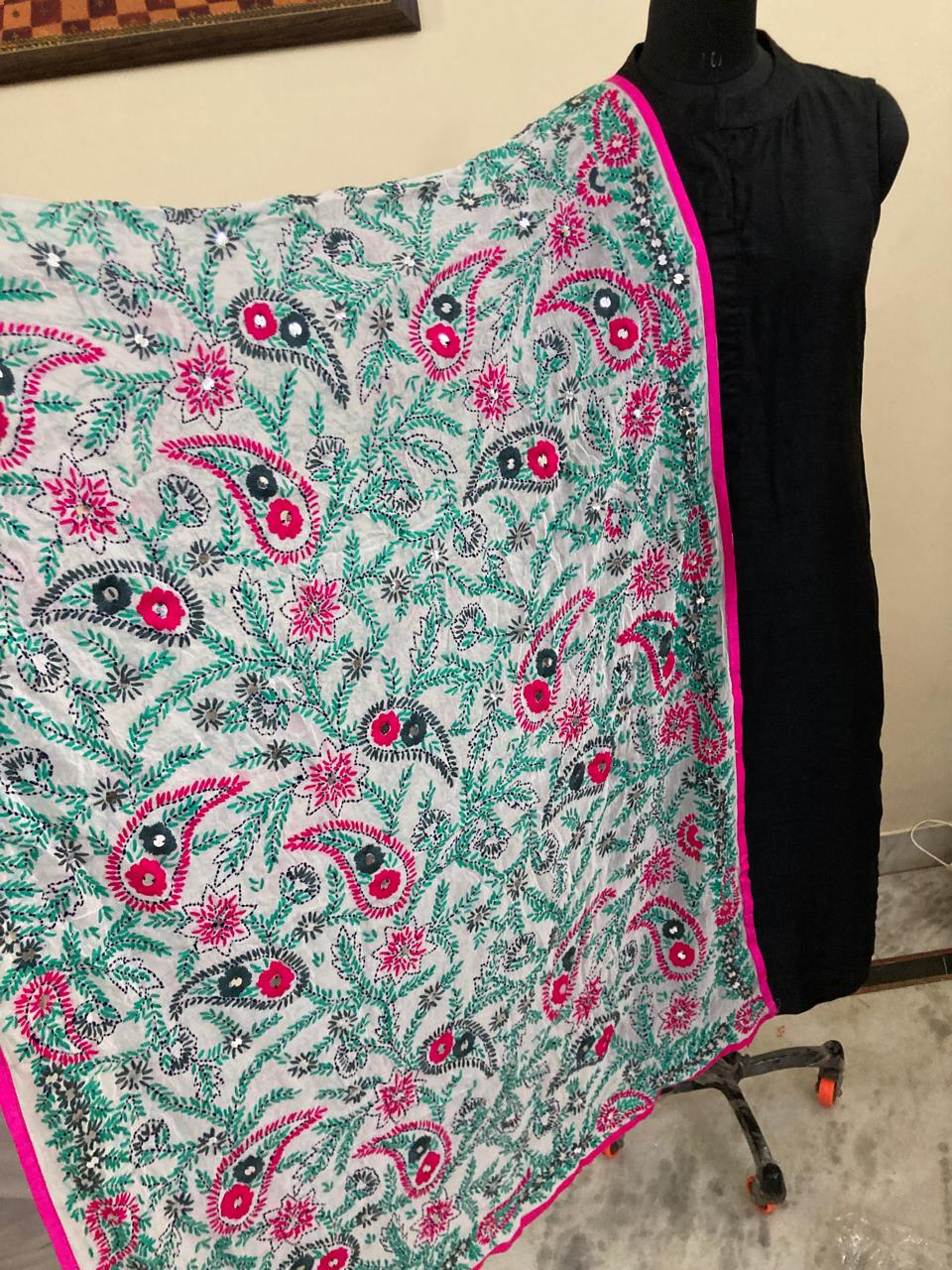 Floral patterned fabric draped over a mannequin against a neutral background