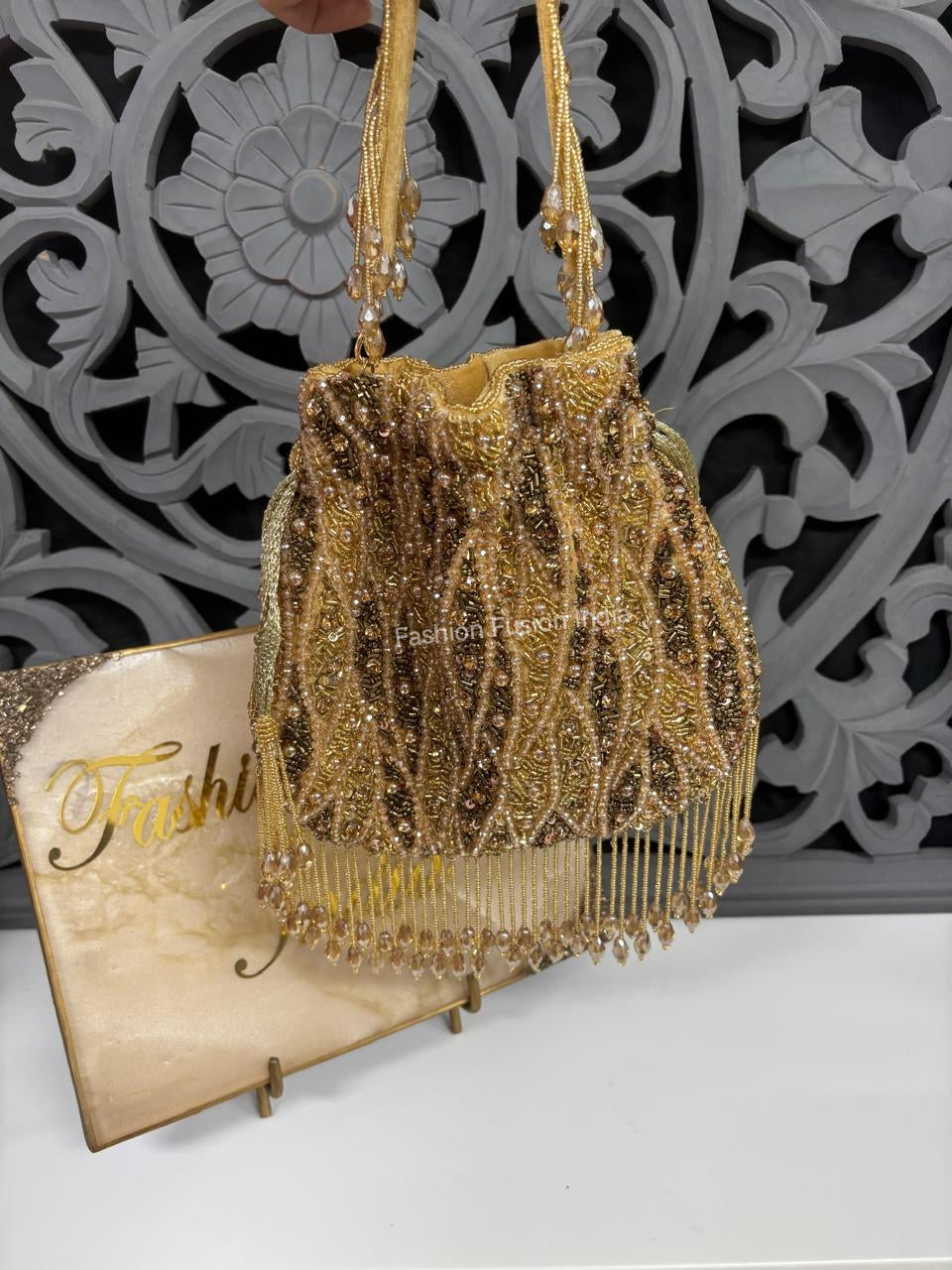 Gold beaded handbag with decorative background
