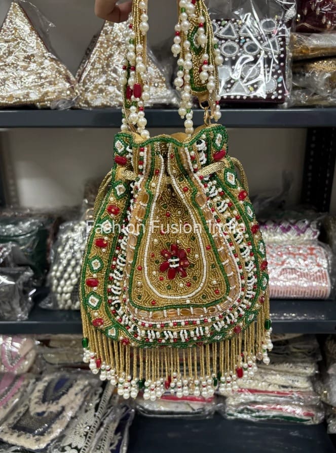 Decorative handbag with intricate designs and pearl details on a blurred background