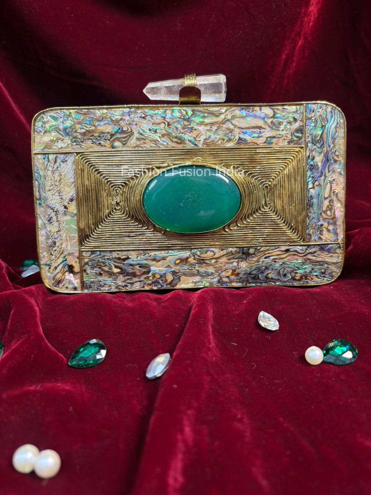 Decorative clutch with gemstones on a red velvet background