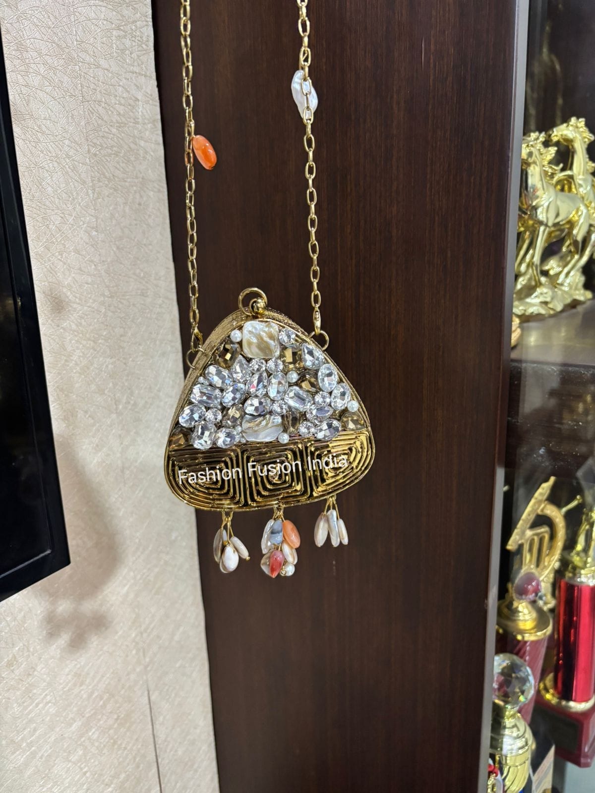 Decorative handbag with embellishments on a wooden surface