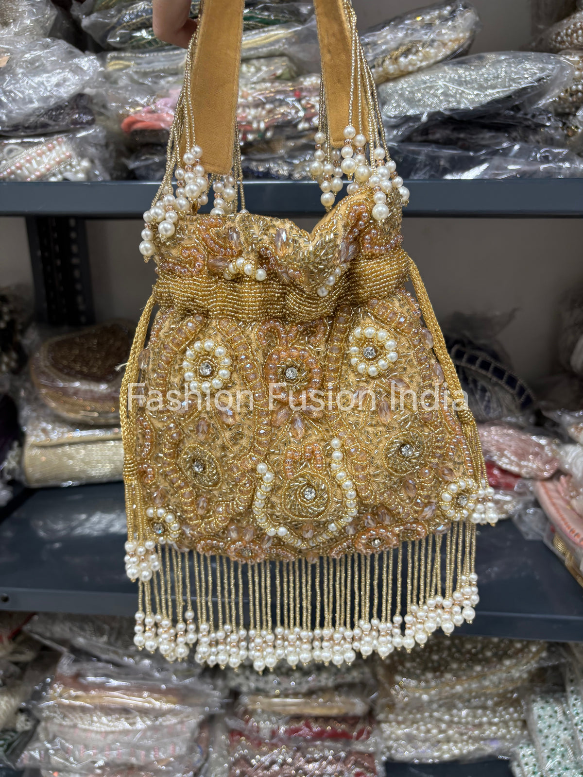 Gold beaded handbag with pearls on a blurred background