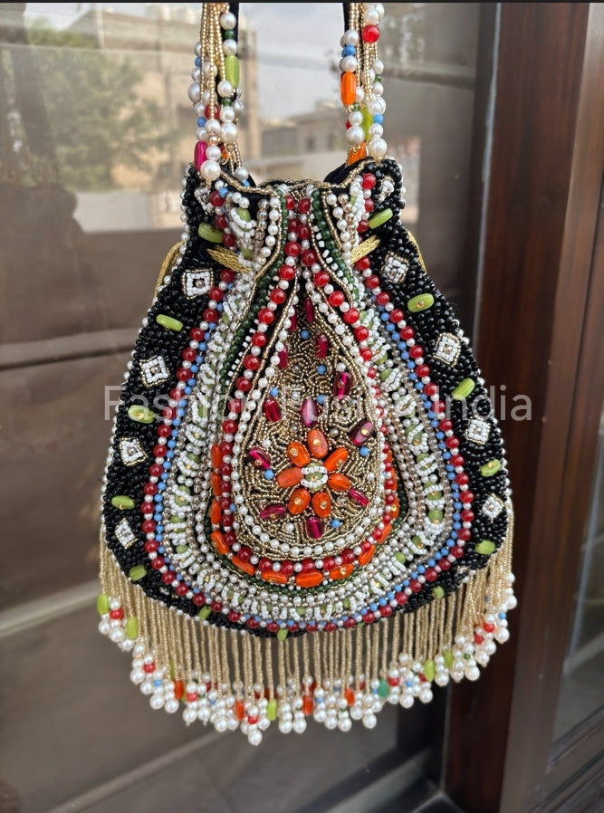 Decorative handbag with beads and embroidery in front of a window