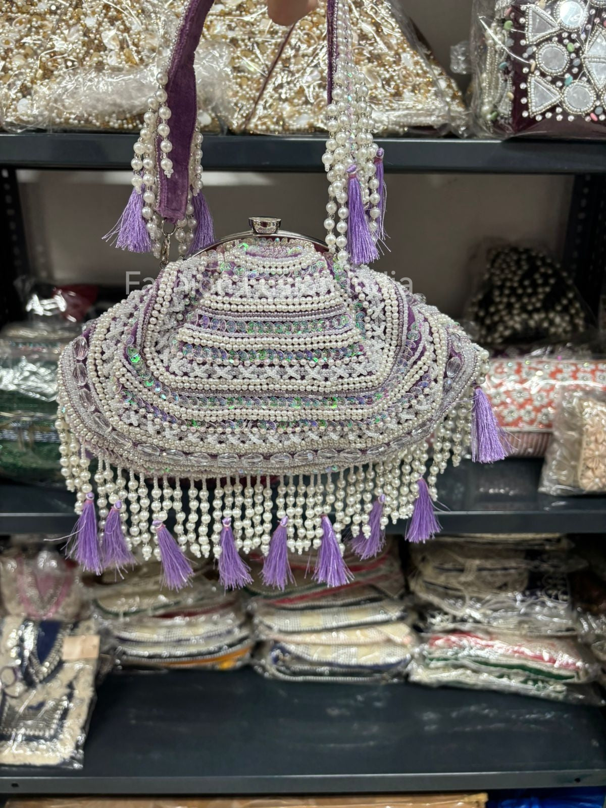 Decorative headpiece with beads and tassels on a shelf with other decorative items.