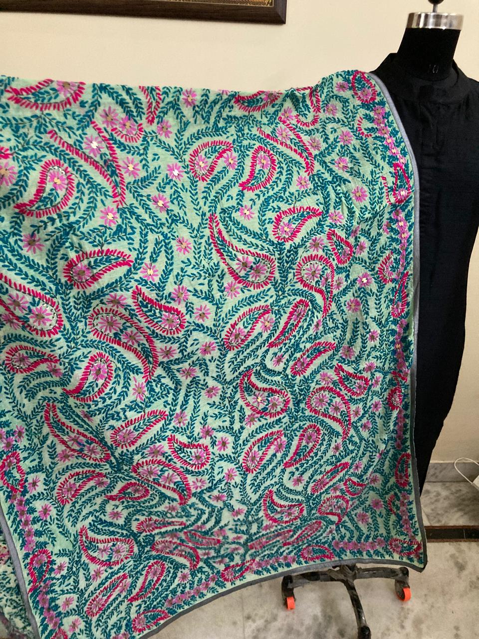 Floral patterned fabric on a mannequin with a plain background