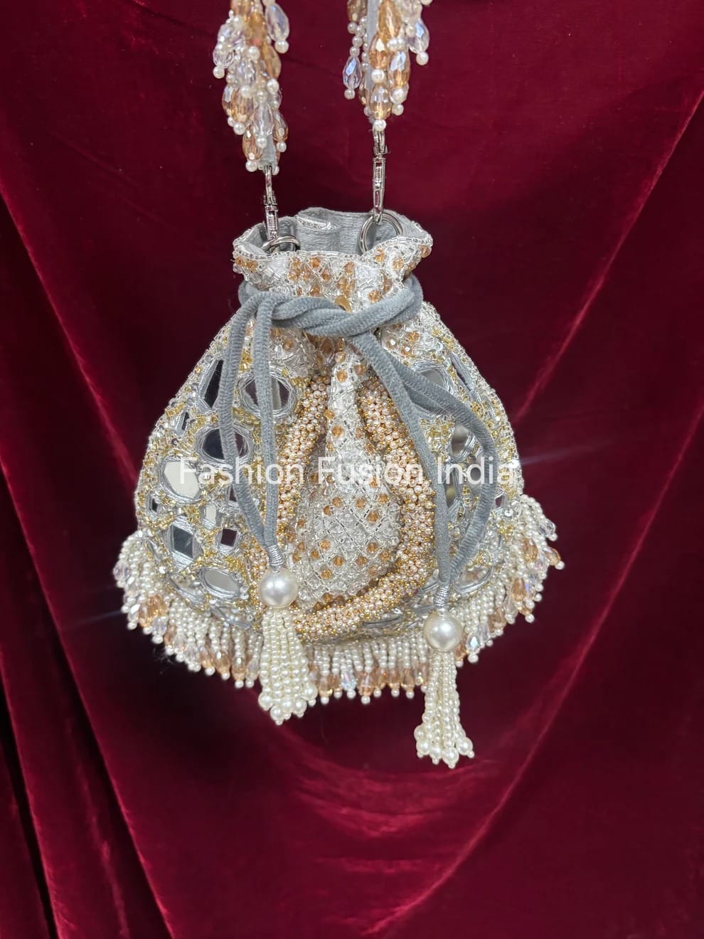 Decorative handbag with intricate beadwork on a red fabric background