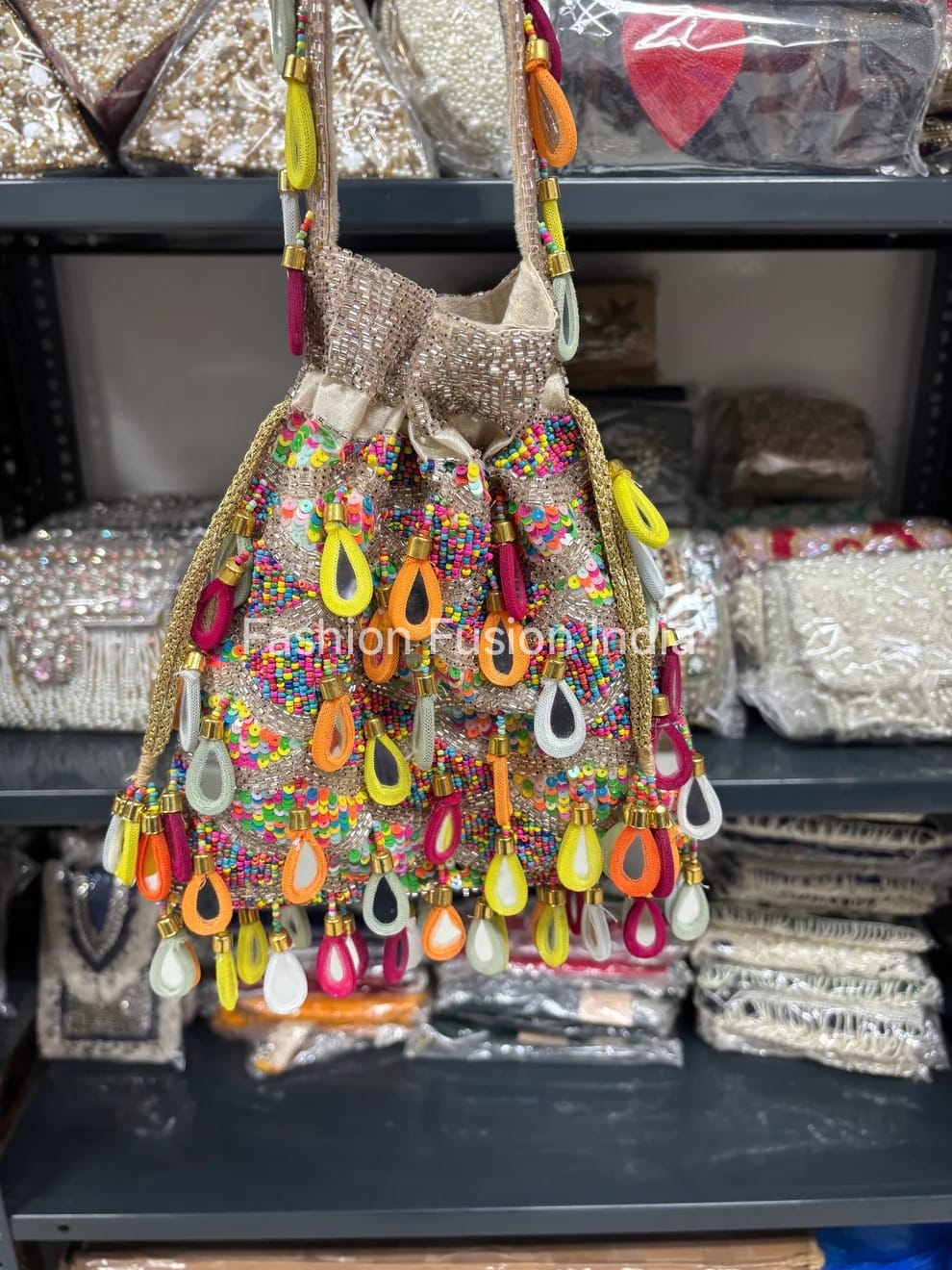 Colorful beaded handbag with decorative elements on a shelf.