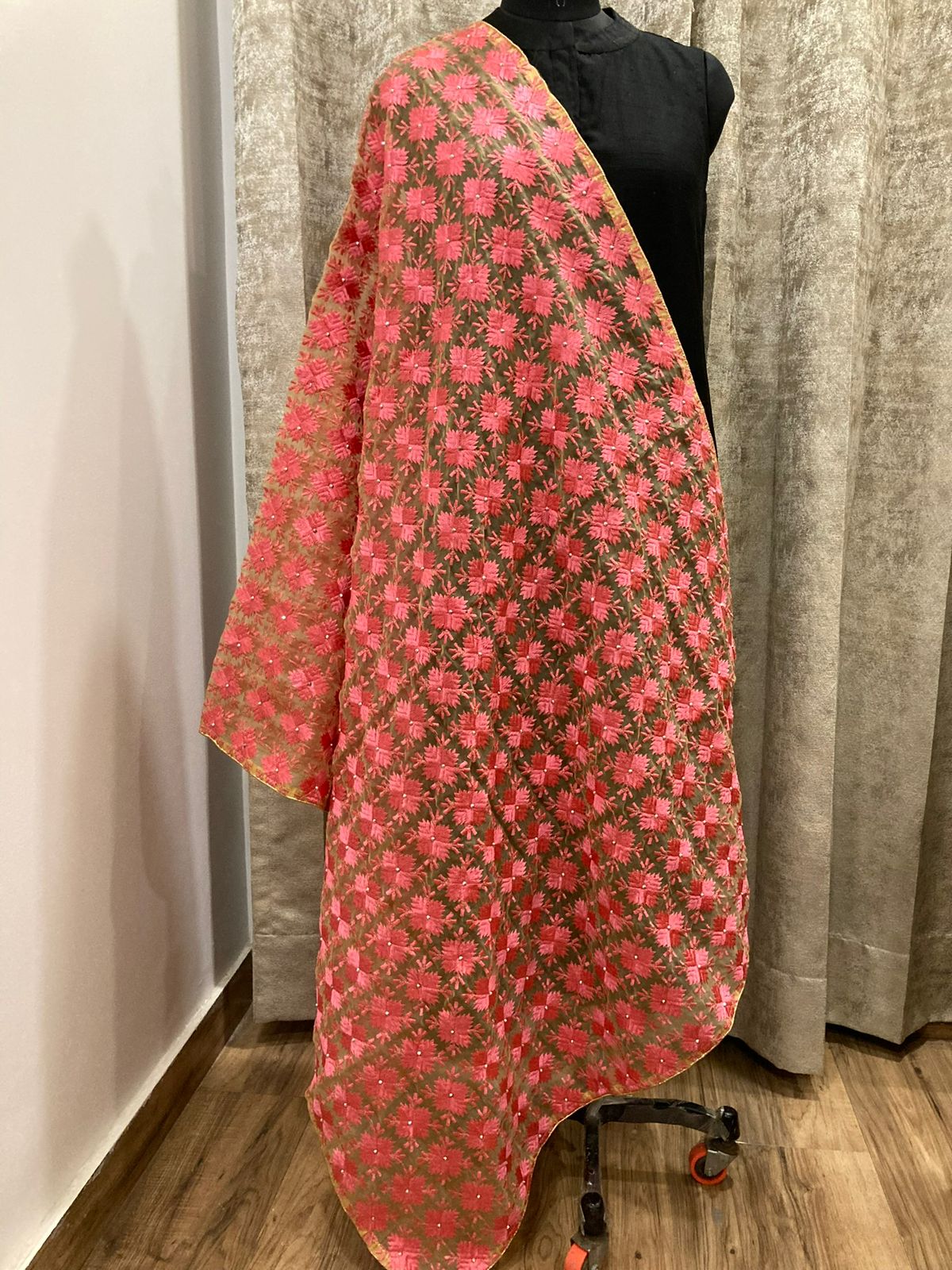 Floral patterned fabric draped over a mannequin against a neutral background