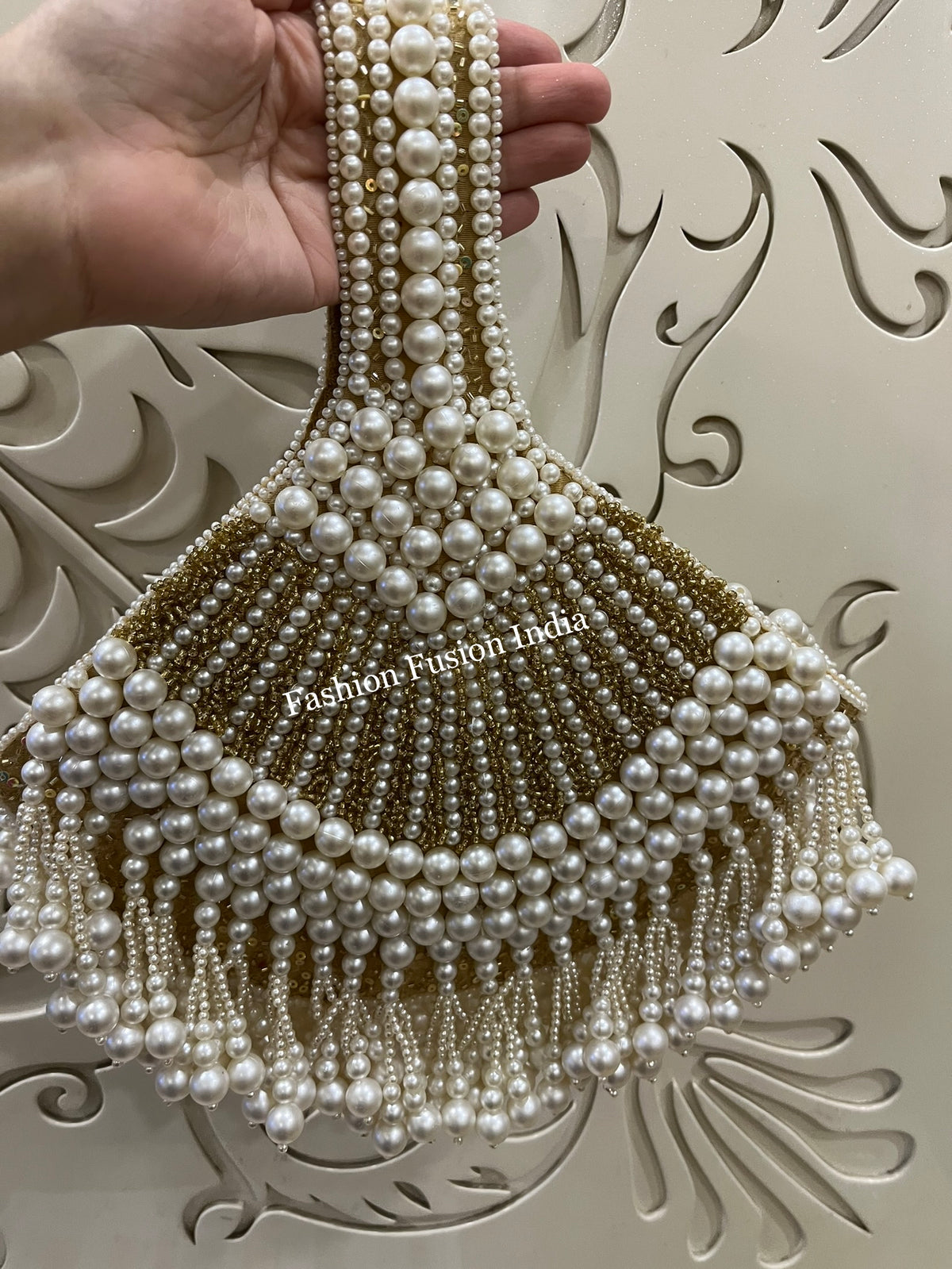 Pearl beaded fan-shaped clutch bag with elegant fringe detailing for festive and bridal looks.