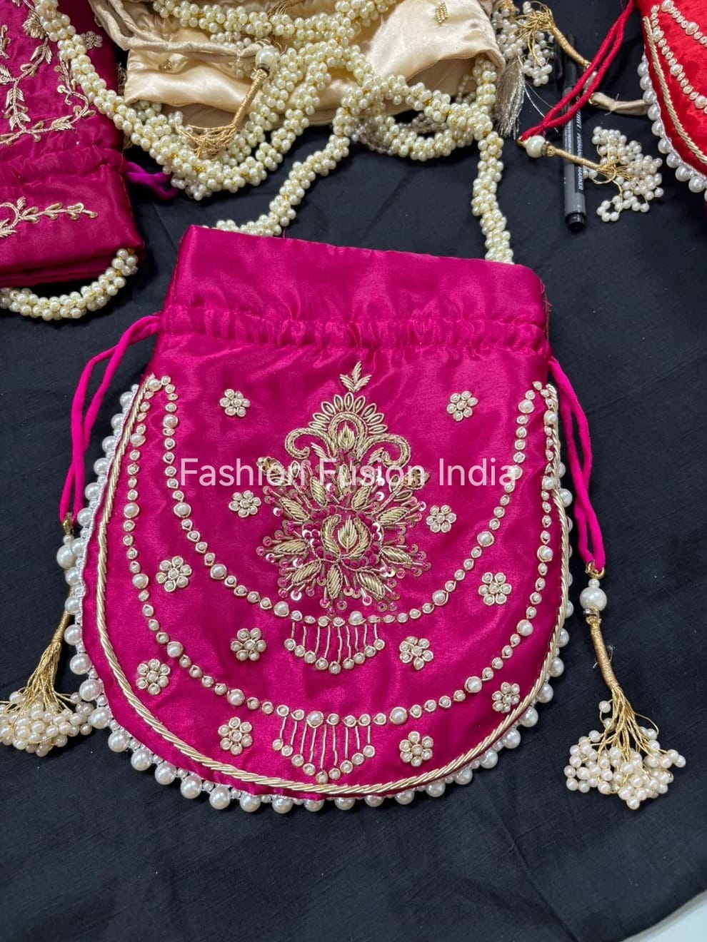 Pink embroidered bag with gold detailing on a dark background, branded 'Fashion Fusion India'.