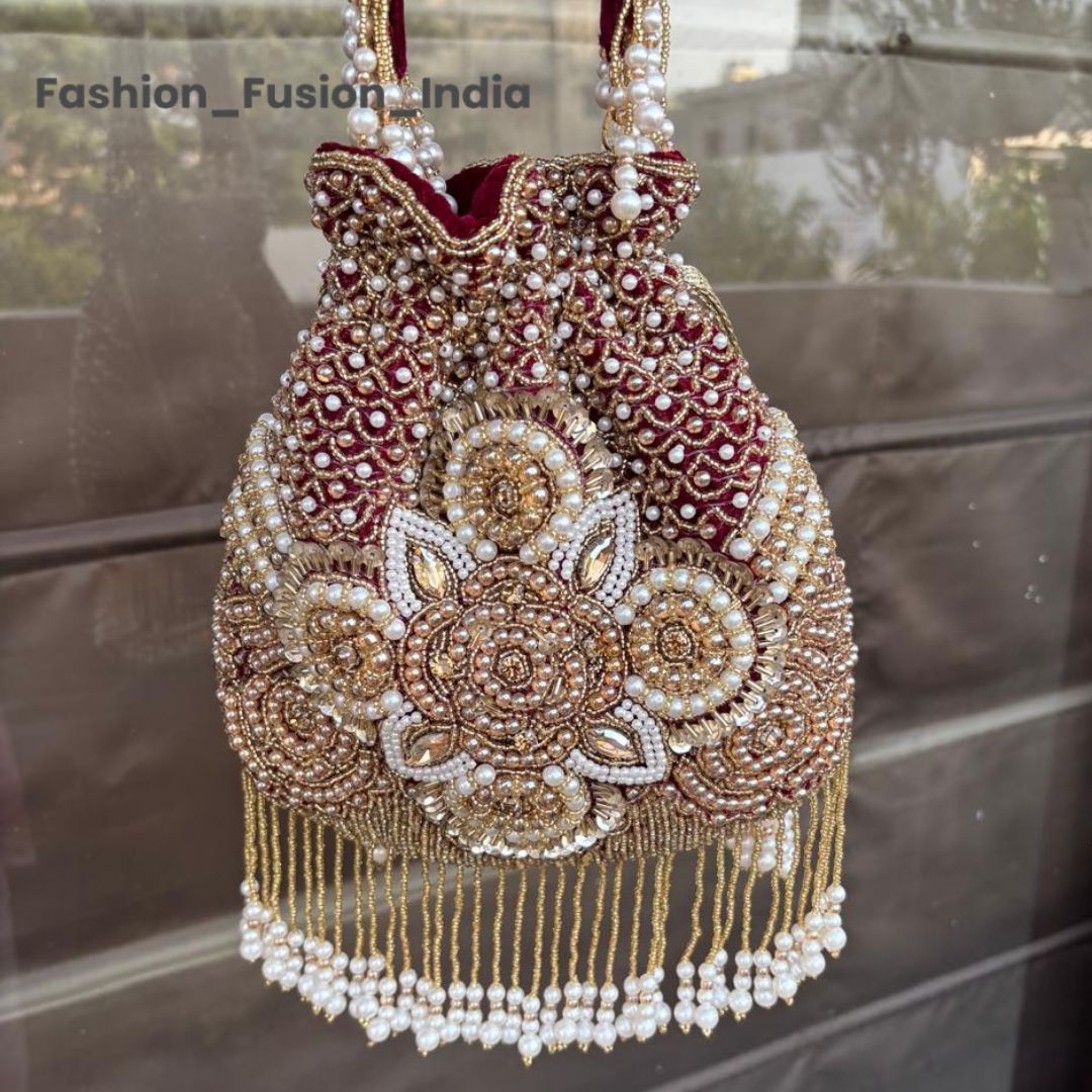 Decorative handbag with intricate beadwork and embroidery on a reflective surface.