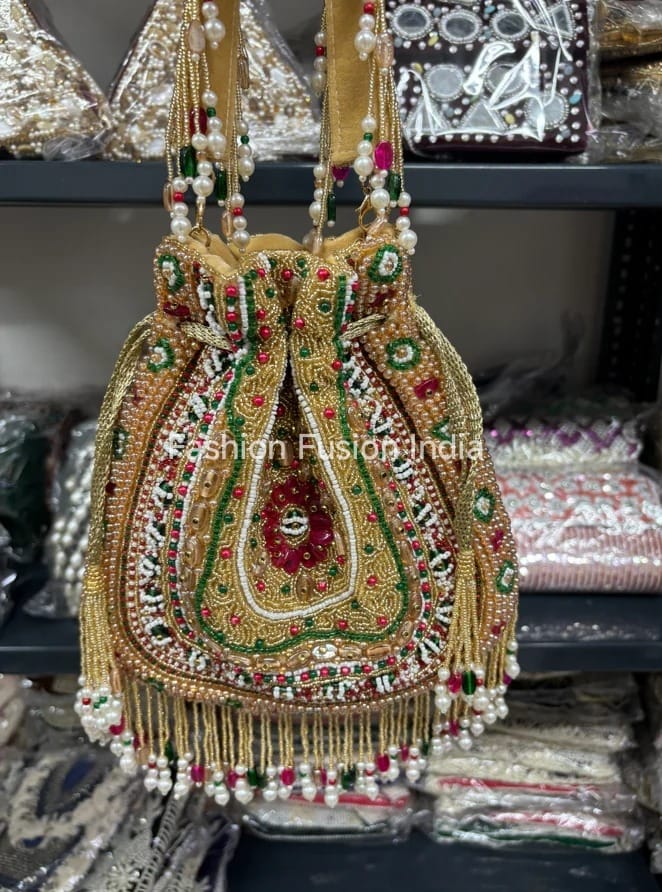 Decorative handbag with intricate designs and beads, featuring the brand 'Fashion Fusion India'.