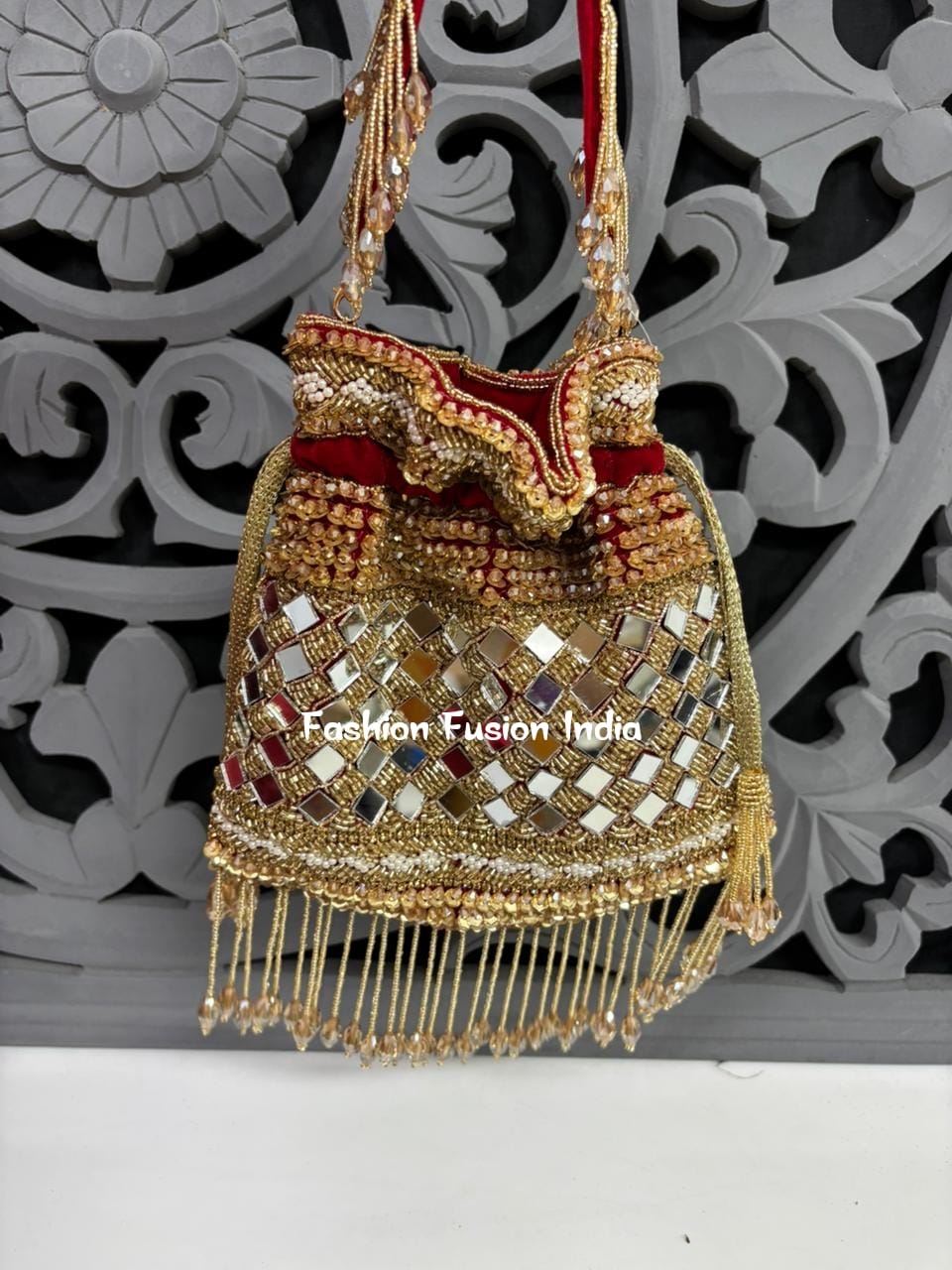 Decorative handbag with gold and red details on a decorative background