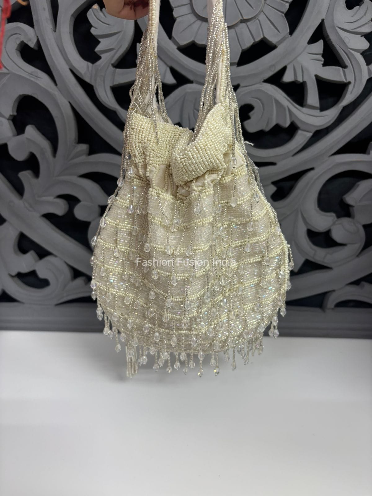 Beaded handbag with intricate design on a decorative background