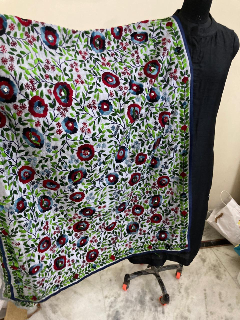 Floral patterned fabric draped over a mannequin