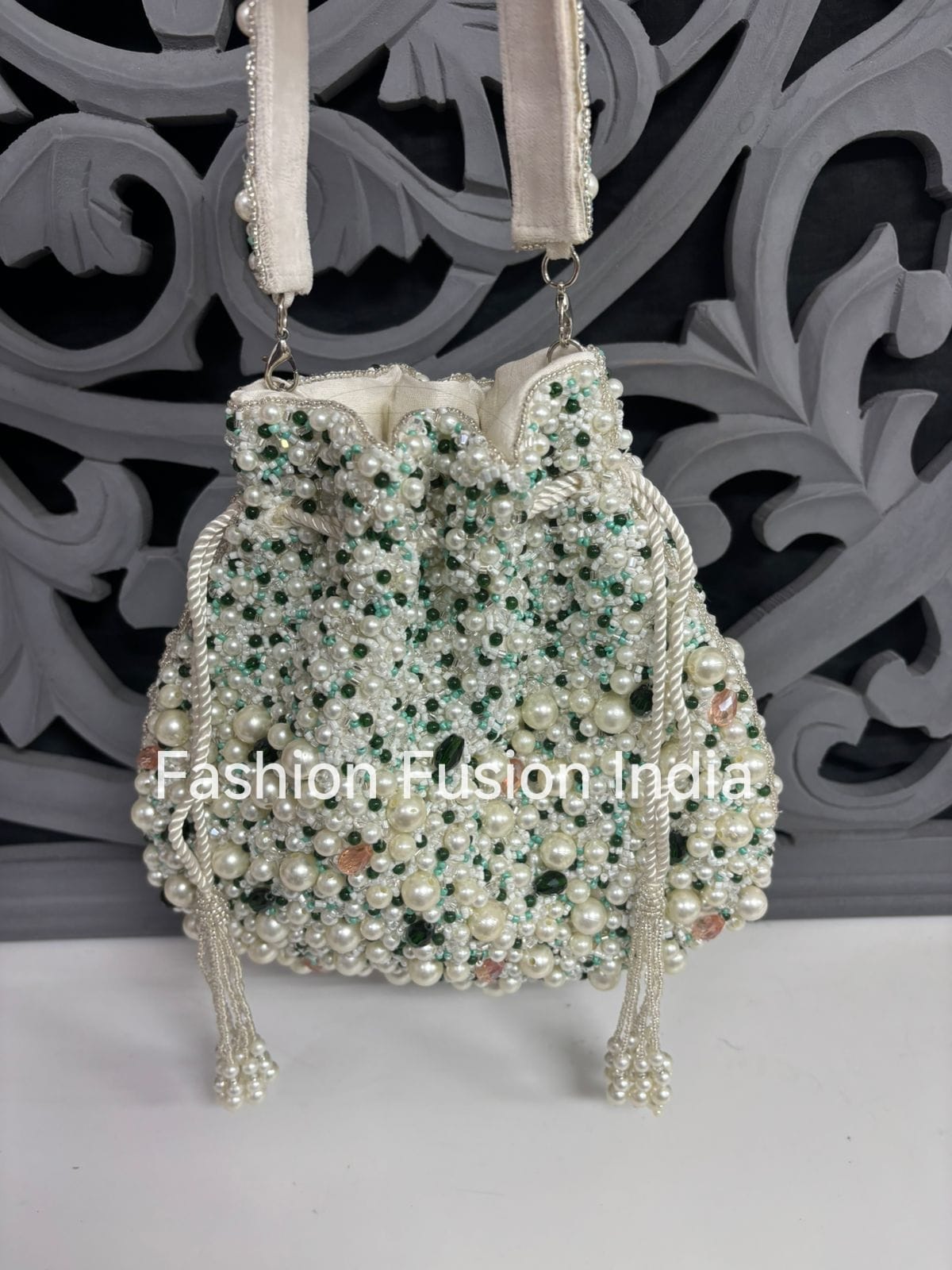 Decorative handbag with pearls and crystals on a decorative background