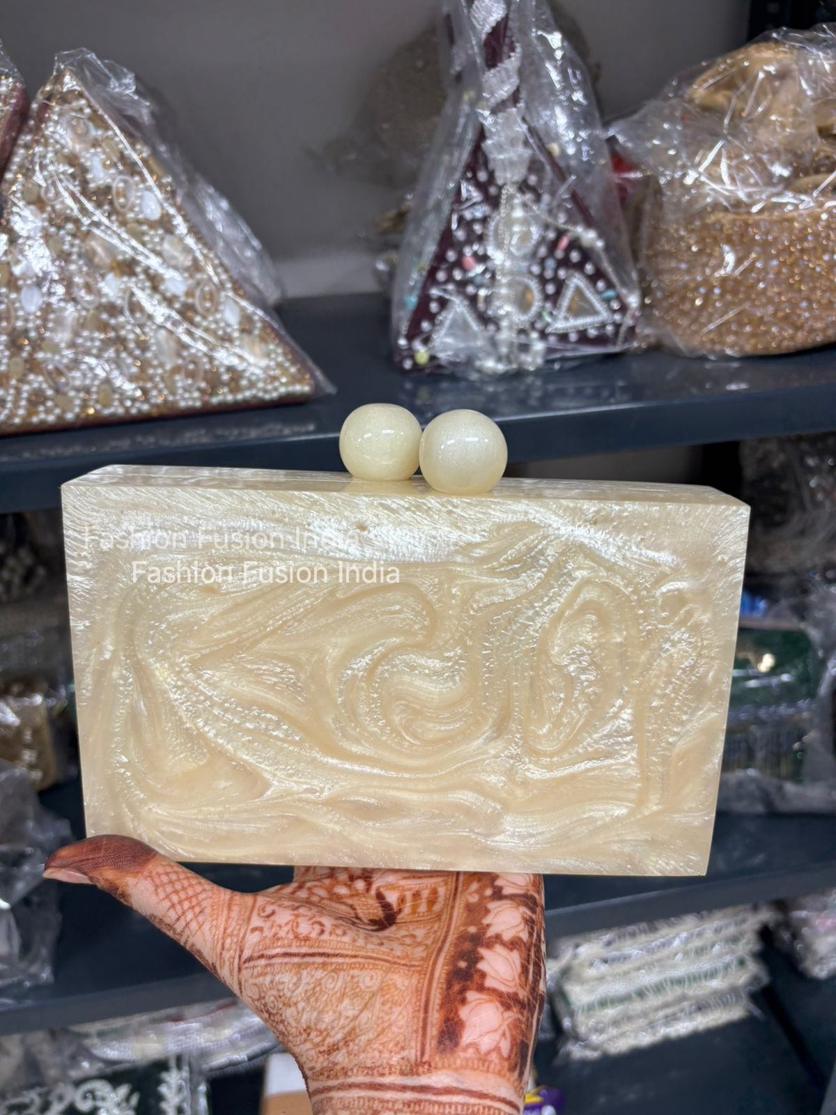 Handmade soap with decorative design held by a hand, with 'Fashion Fusion India' branding.
