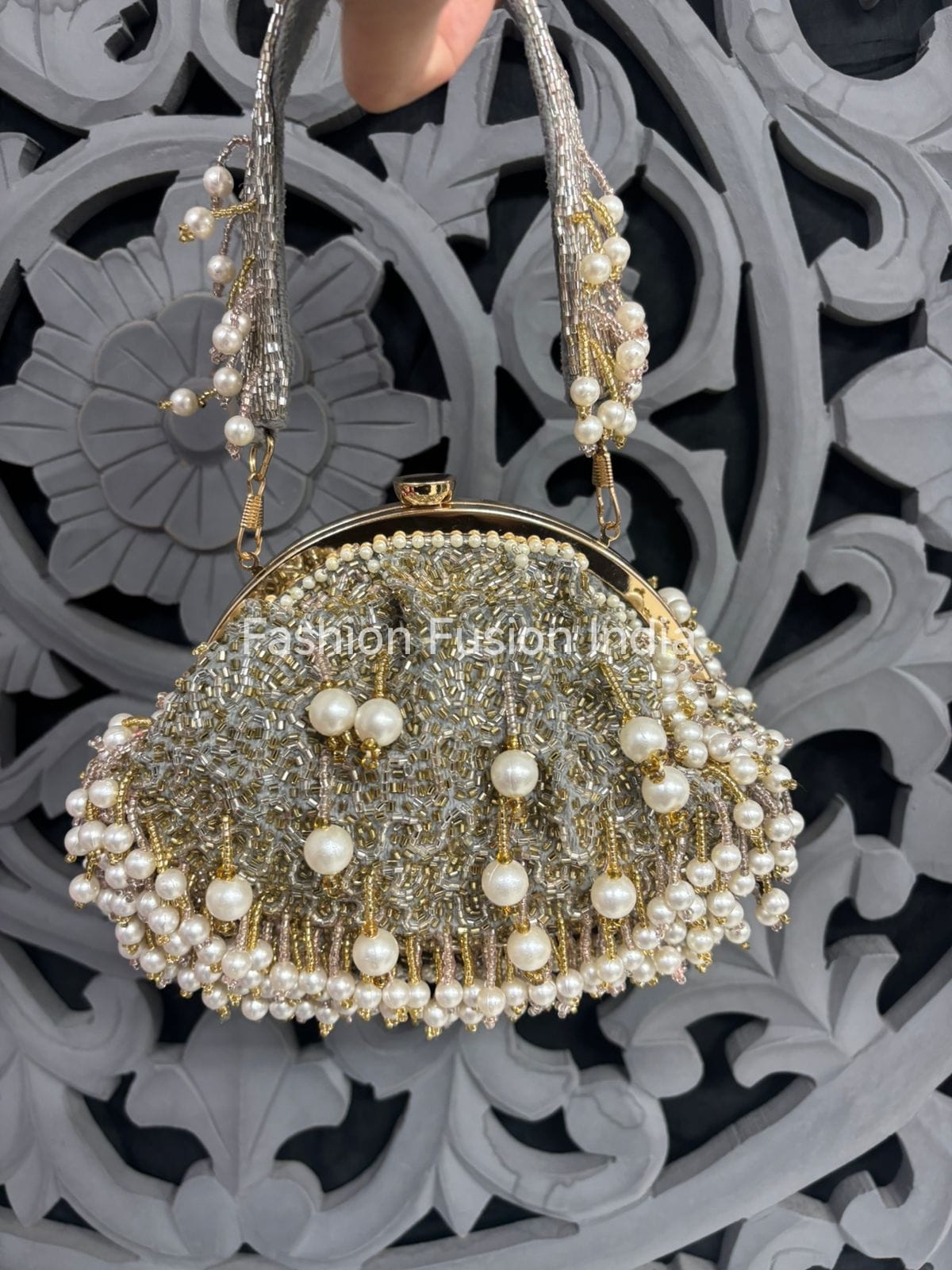 Decorative handbag with pearls against a decorative background