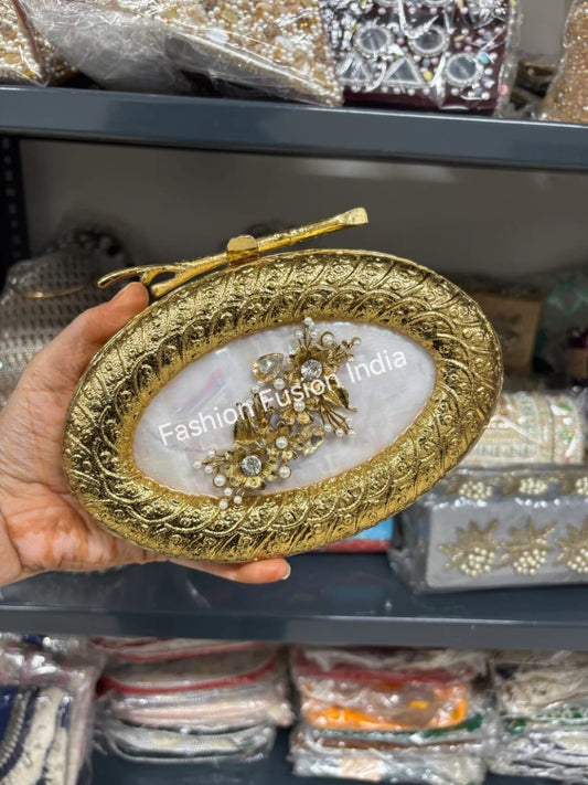 Decorative gold jewelry box with 'Fashion Fusion India' branding held by a hand.