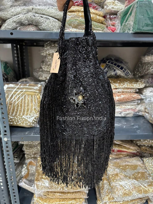 Black beaded handbag with a tag on a shelf with similar bags in the background.