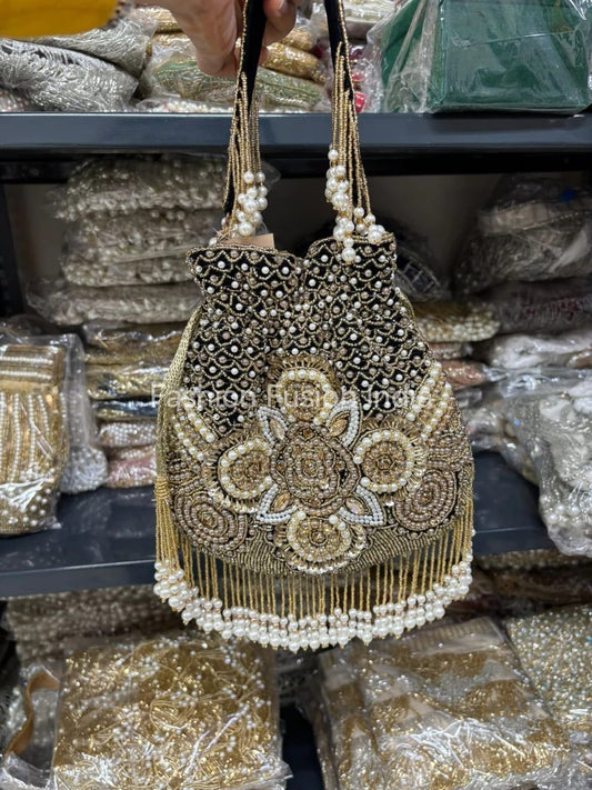 Decorative handbag with beaded details on a display with other bags.
