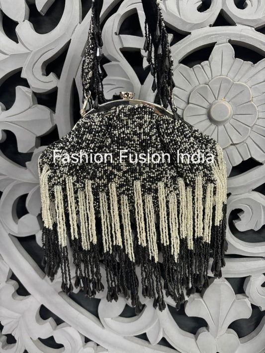 Black beaded handbag with fringe details on a decorative white background