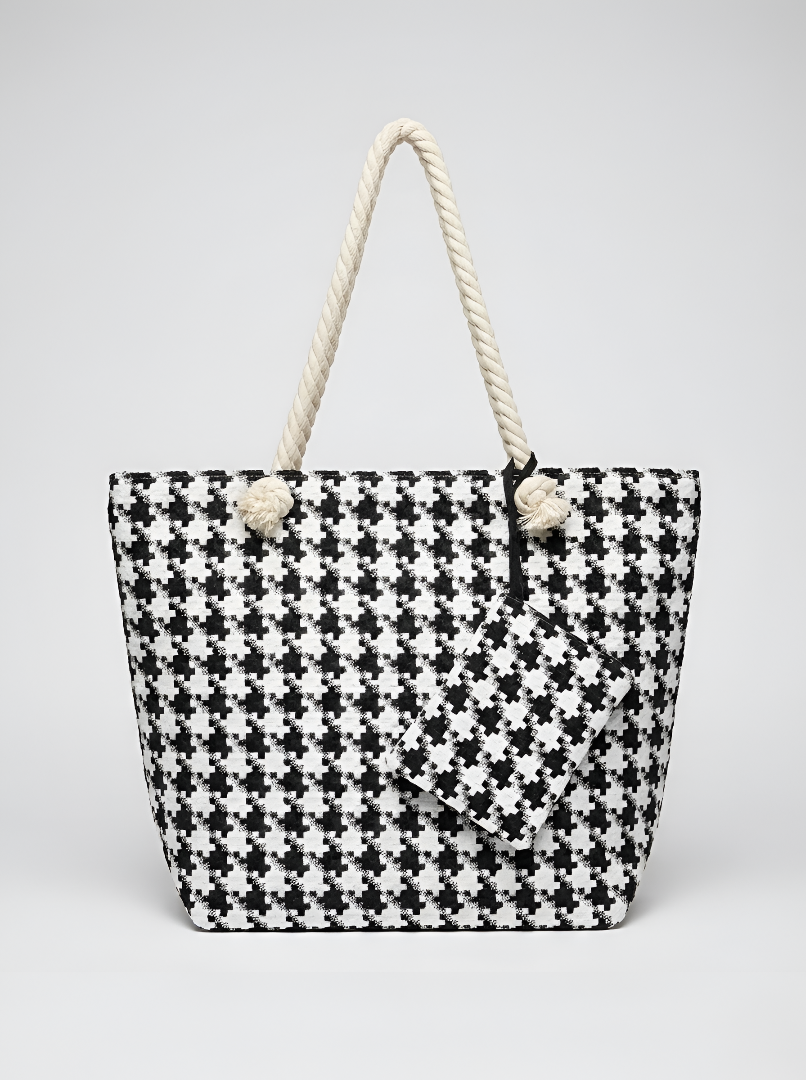 Black and white checkered tote bag with rope handles on a light gray background