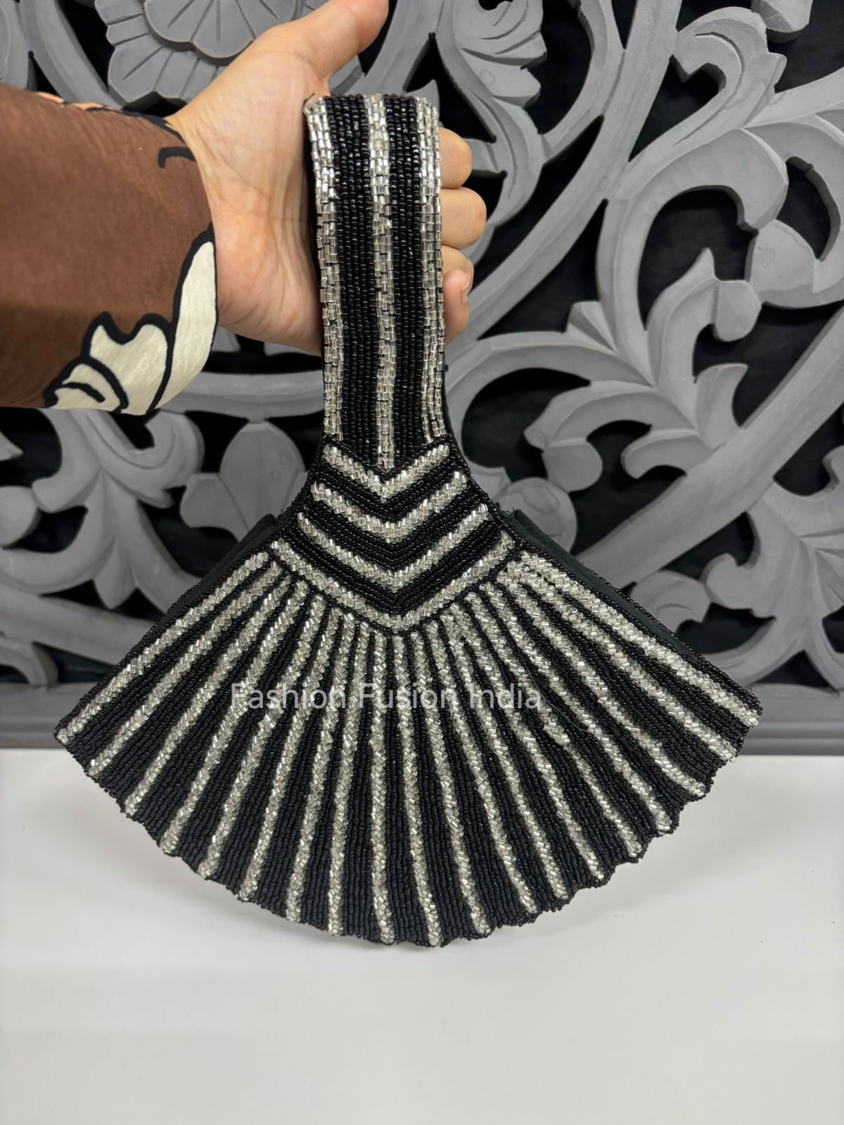 Black and silver beaded fan-shaped potli bag with elegant striped embroidery.
