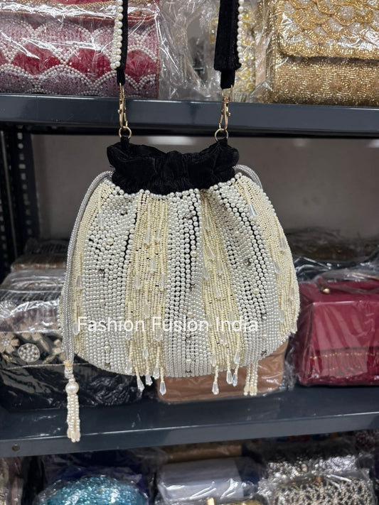 Beaded handbag with black top on a shelf with other bags in the background.