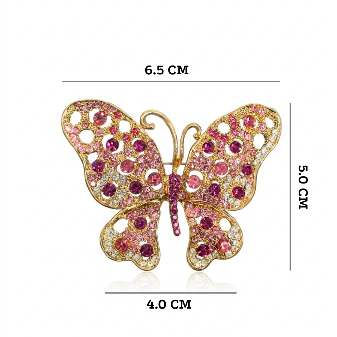 Butterfly-shaped brooch with pink and red gemstones and measurements on a white background