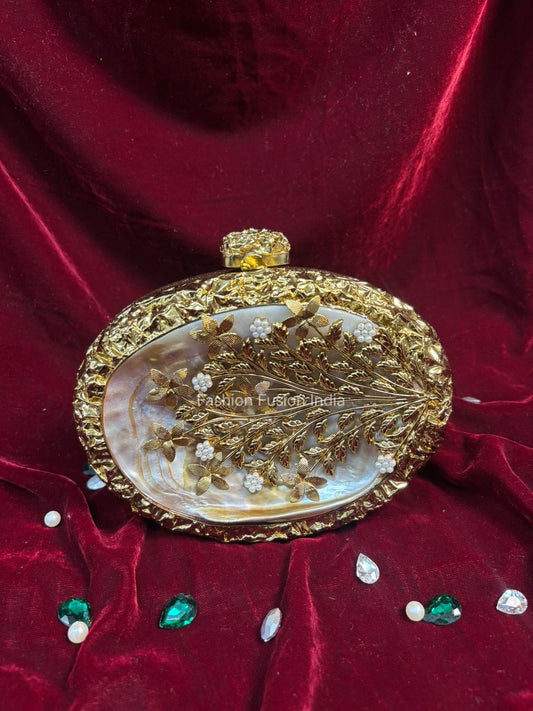 Decorative gold clutch bag on a red fabric background