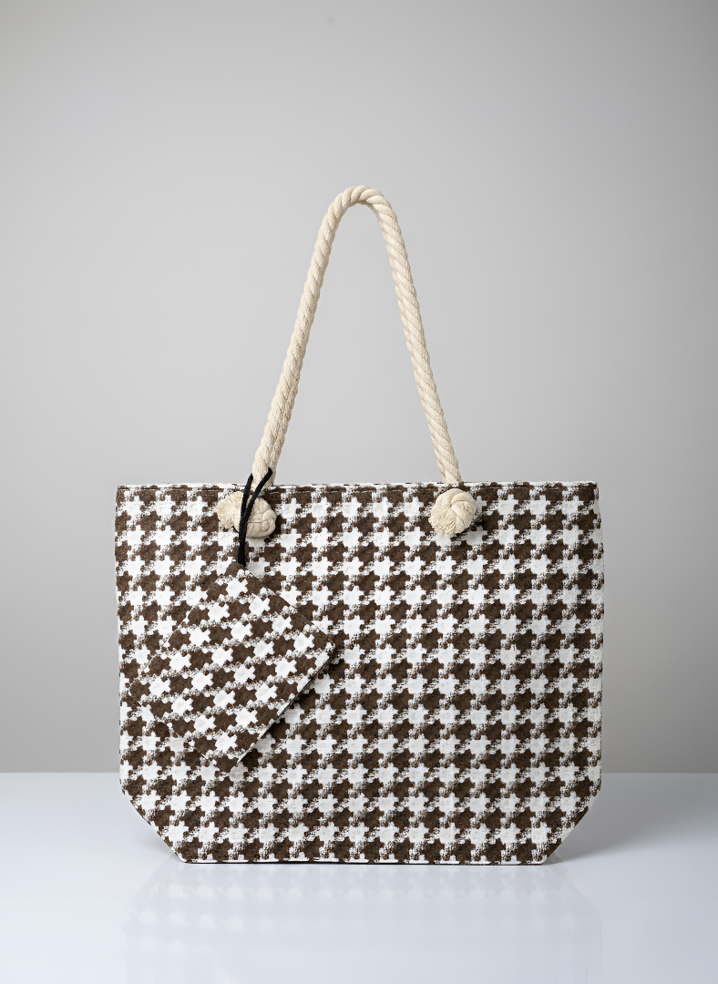 Houndstooth patterned tote bag with rope handle on a gray background