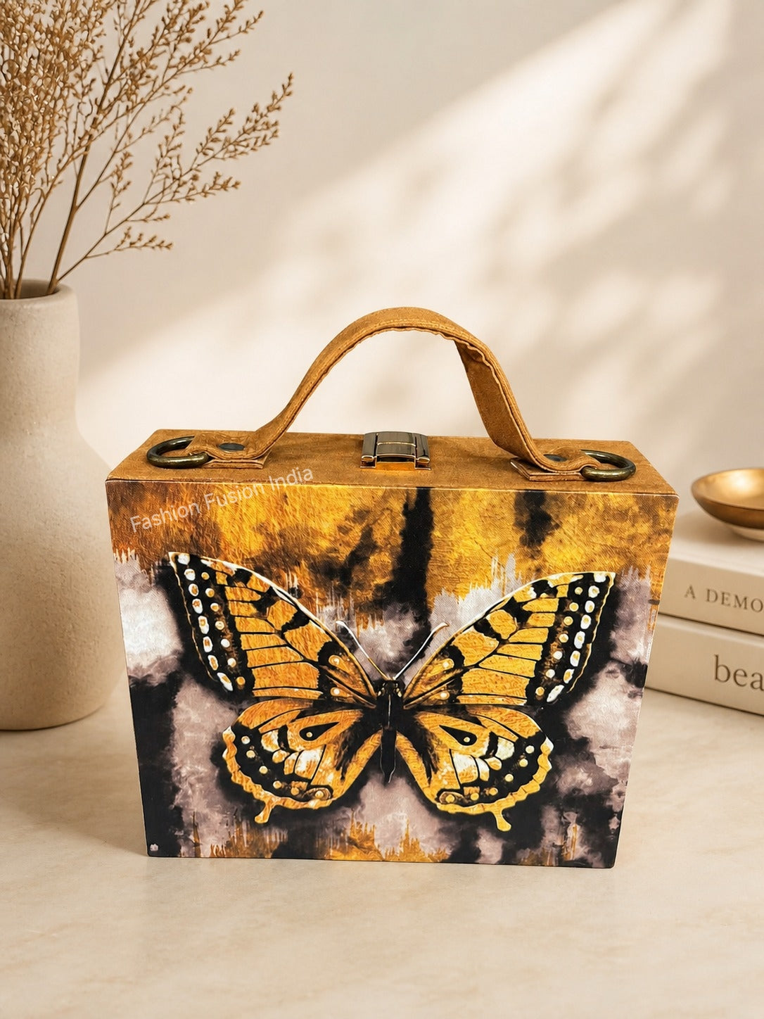 Butterfly print wooden clutch bag with warm golden artwork on beige décor background.