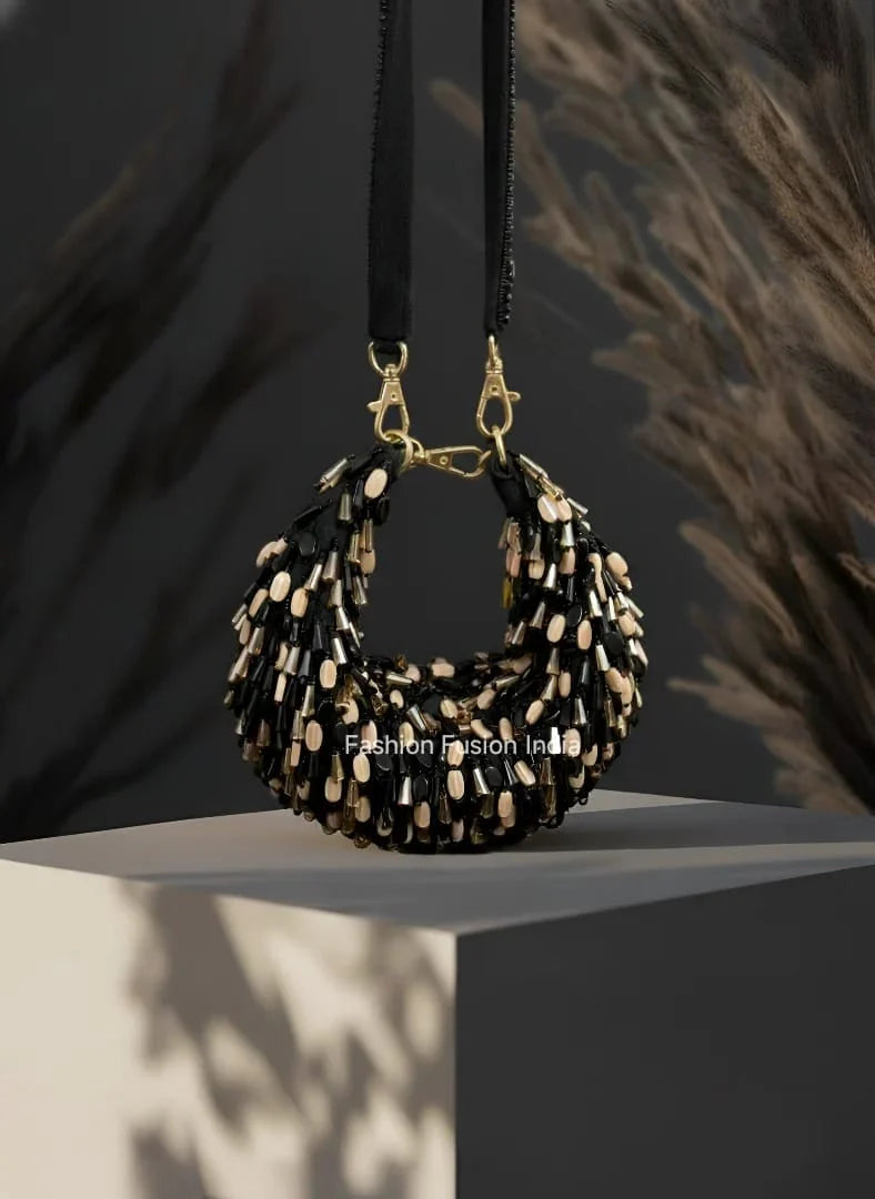 Black and gold beaded handbag on a dark background
