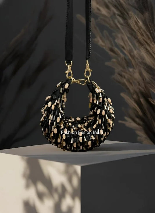 Black and gold beaded handbag on a dark background