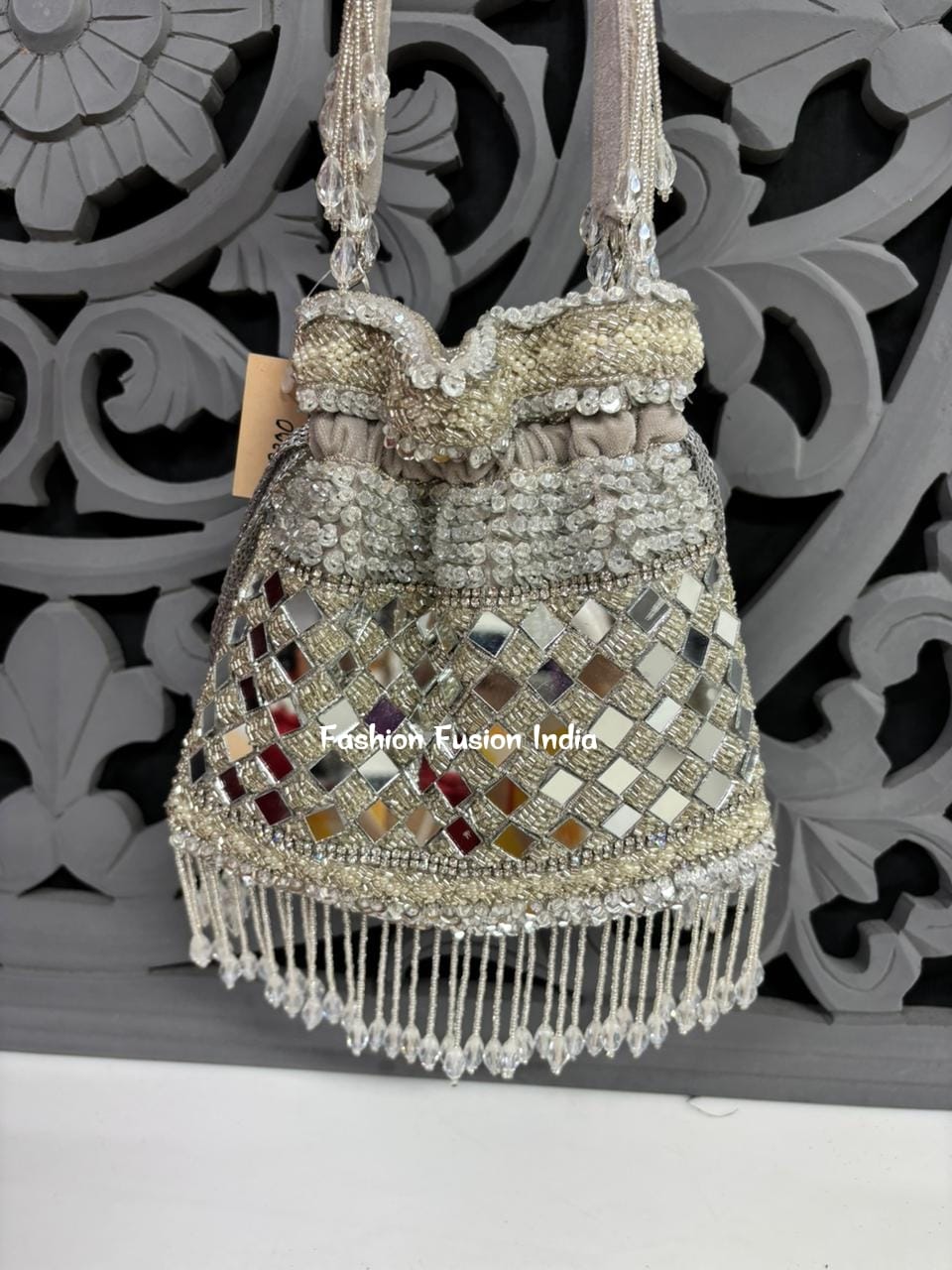 Decorative handbag with beads and fringes on a decorative background