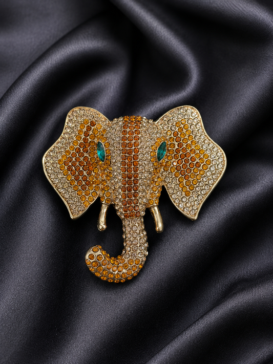 Elephant-shaped brooch with gemstones on a black satin background