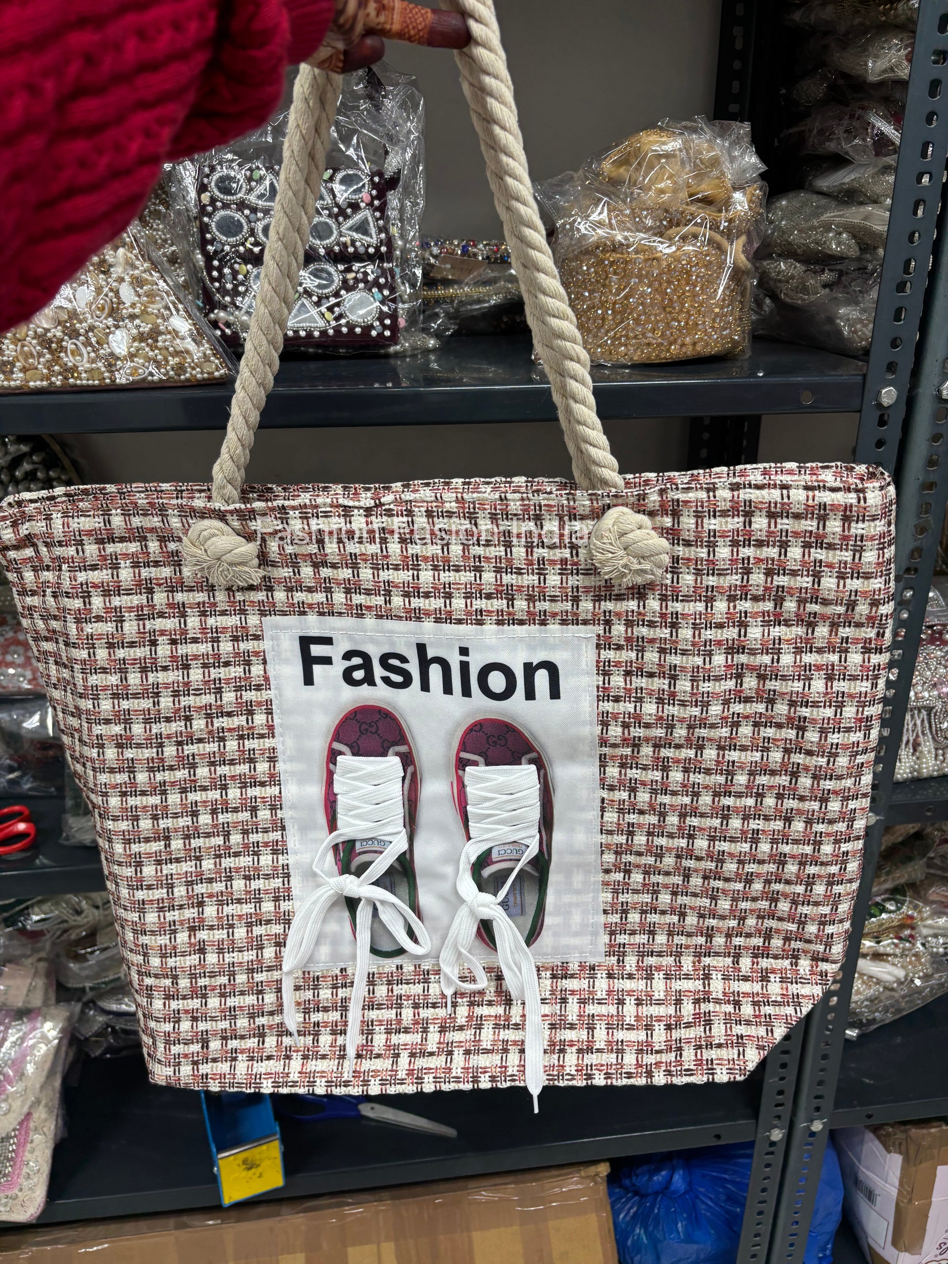 Woven tote bag with 'Fashion' and shoe design on a store shelf
