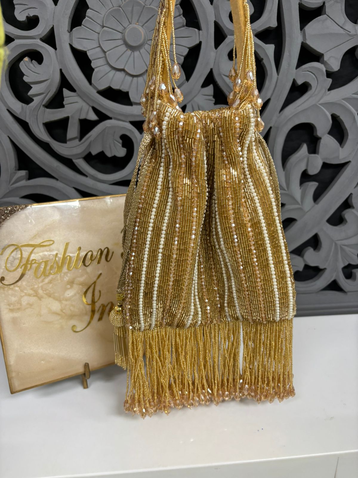 Gold beaded handbag with decorative background