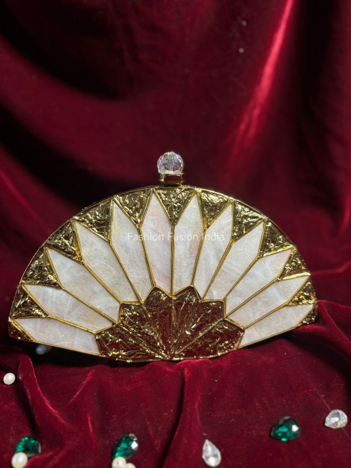 Decorative handbag with gold and white design on a red fabric background