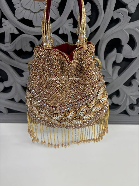 Decorative handbag with gold beads and tassels on a white background