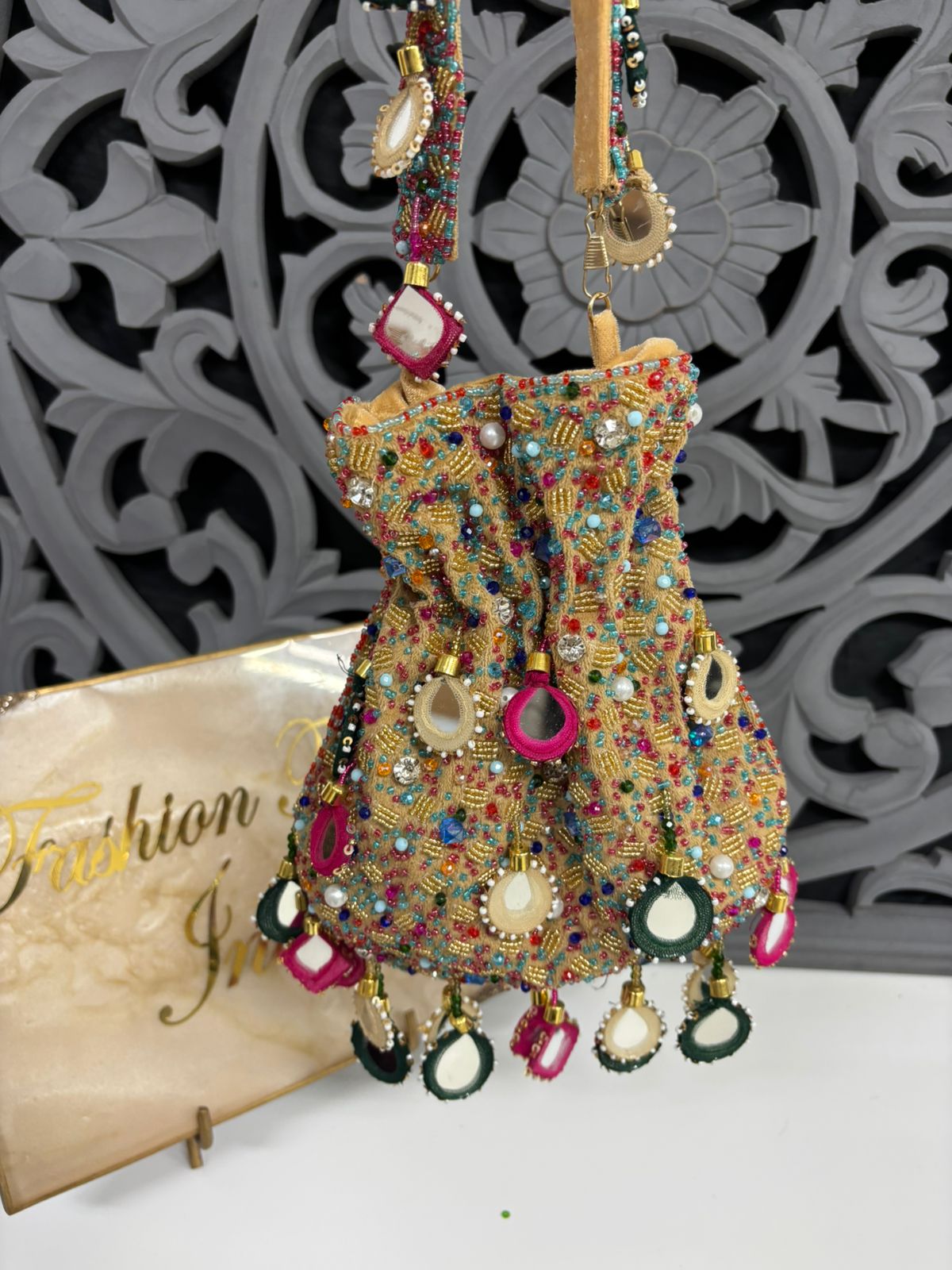 Decorative handbag with colorful beads and patterns on a decorative background