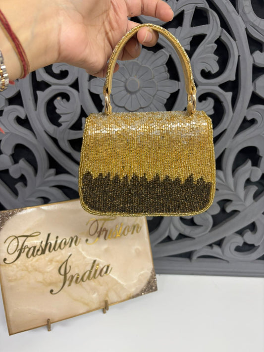 Gold glitter handbag held by a hand with a decorative background and 'Fashion India' sign.