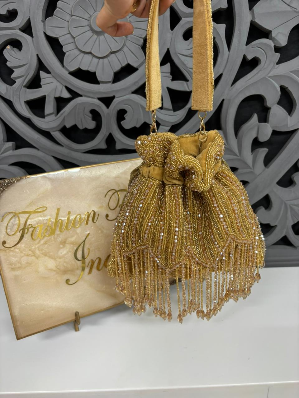 Gold beaded handbag with decorative background