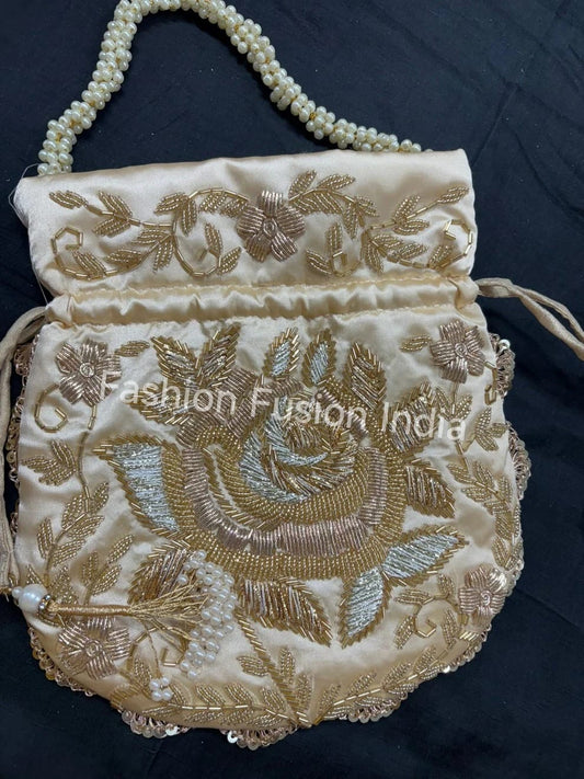 Decorative handbag with intricate gold embroidery on a dark background, branded 'Fashion Fusion India'.