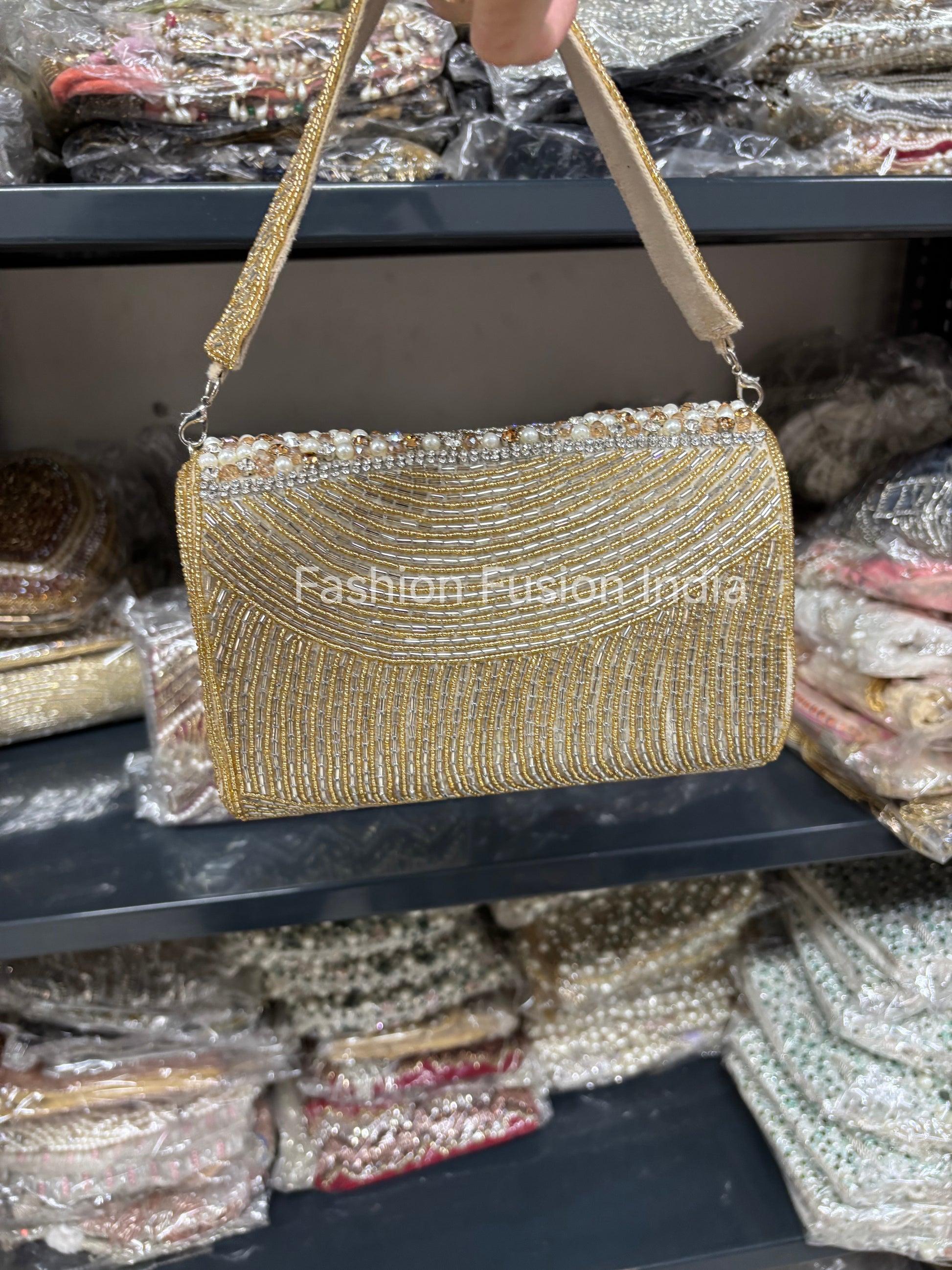 Gold beaded handbag on a shelf with 'Fashion Fusion India' branding.