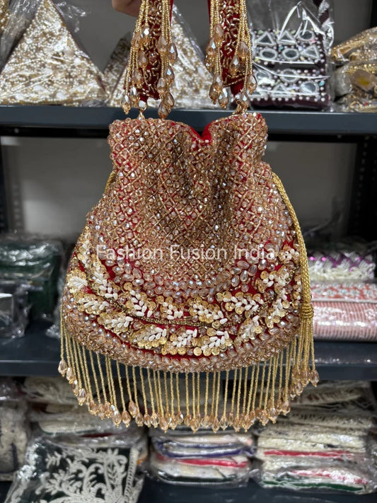 Decorative handbag with gold and red details on a blurred background